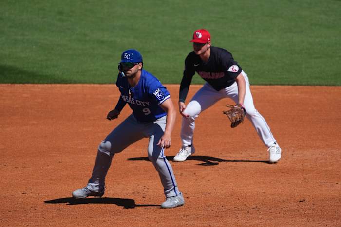 Mar 2, 2024; Goodyear, Arizona, USA; Kansas City Royals first baseman Vinnie Pasquantino (9) leads off first base base as Cleveland Guardians first baseman Kyle Manzardo (73) covers the bag during the second inning at Goodyear Ballpark.
